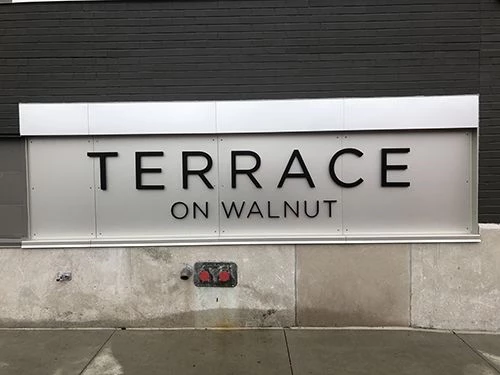 Exterior Black Vertical Cast Aluminum Dimensional Letters for Terrace on Walnut Apartments in Kansas City, Missouri