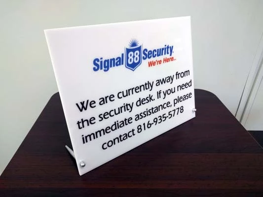 White Acrylic Desk Sign with Conical Standoffs for Signal 88 Security in Kansas City, Missouri